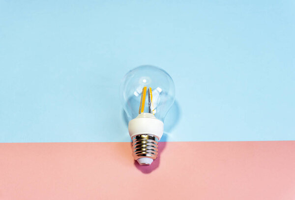 Light bulb ( lightbulb) on a colored background. Minimal concept