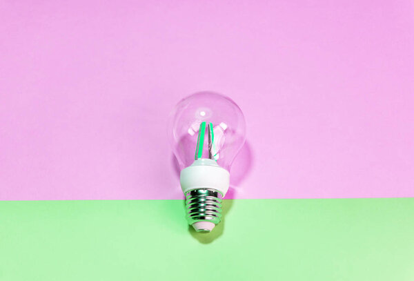 Light bulb ( lightbulb) on a colored background. Minimal concept