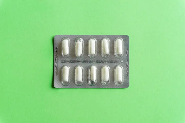 Packs of pills (drugs) on a colored background. Minimal concept. — Stock Photo, Image