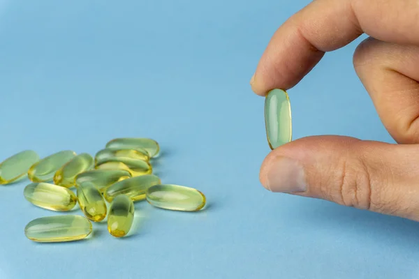 Fish oil (fish fat) capsules. Omega 3 vitamins in yellow gelatin