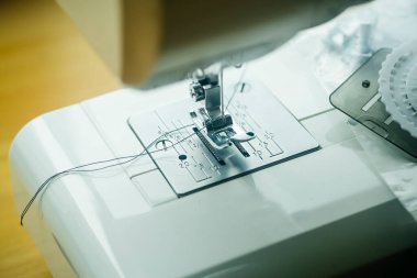 Dikiş makinesi. Dikiş iğnesi ve ipliği olan modern dikiş makinesi. Dikiş ve el işi konsepti.