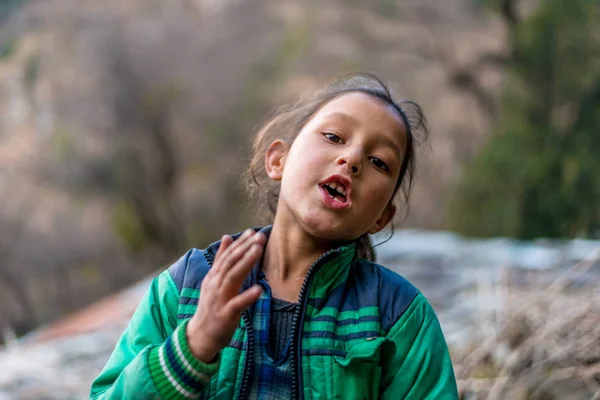 Kullu, Himachal Pradesh, India - April 01, 2019 : Portrait himachali girl near her house on the street in Himalayan village Stock Photo