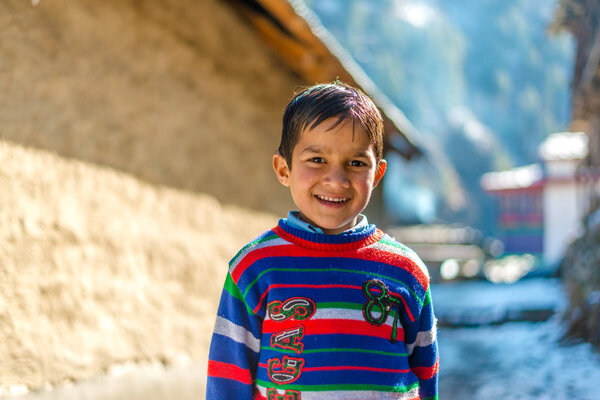 Kullu, Himachal Pradesh, India - January 26, 2019 : Smiling kid boy with stylish hairstyle outdoors. Looking at camera. Teenage boy