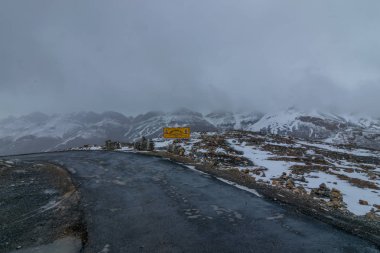 Yol dağlarda kar ile kaplı. Kış manzarası. Özgürlük ve hareket kavramı.