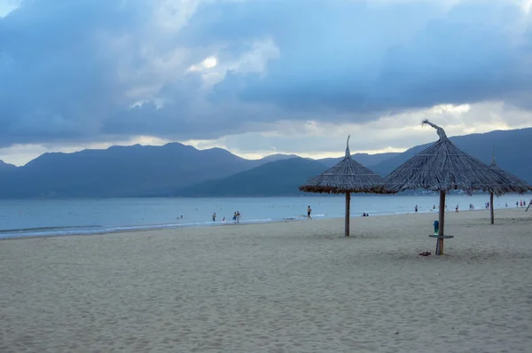 Thatched parasols on the coast, the beach paradise and unspoiled. great and relaxing holiday in southeast asia. Picture use for advertising travel, tourism, design, magazine cover and more