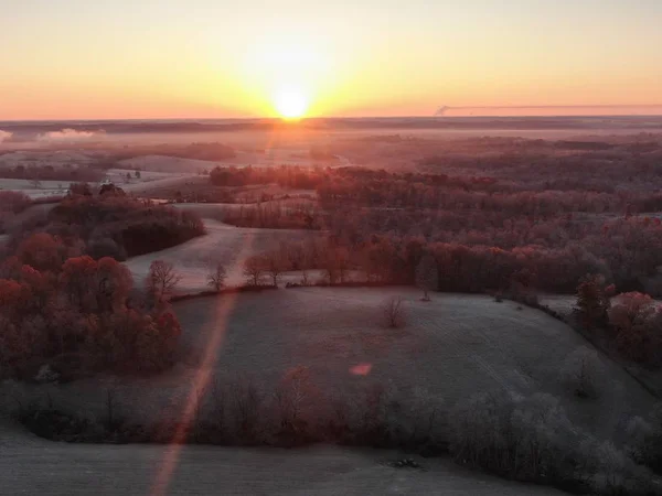 Ormanlı bir manzara üzerinde gün batımının havadan görünümü