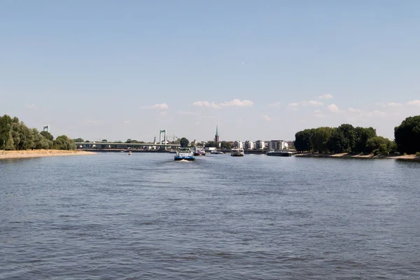 view over the rhine river and its riverbanks in cologne germany photographed during a sightseeing boat tour with wide angle lens