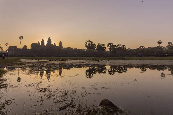 Sunrise view of ancient temple complex Angkor Wat and lake reflection, famous tourist attraction in Siem Reap, Cambodia.