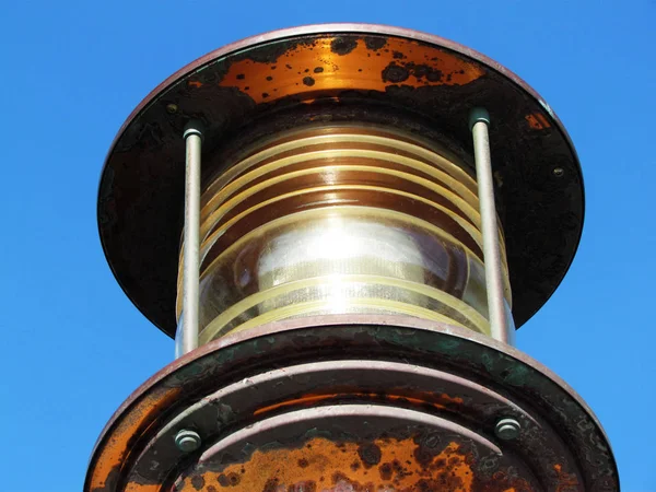 Large copper latern on the entrance on a pier with a blue sky background