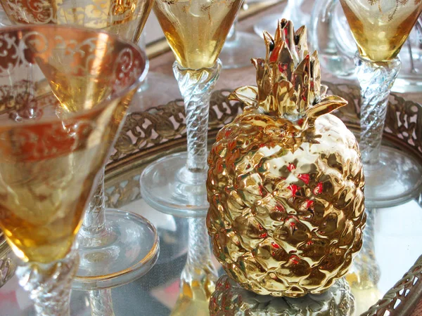 Gold Stem Cocktail glasses with a gold Pineapple on a liquor cart