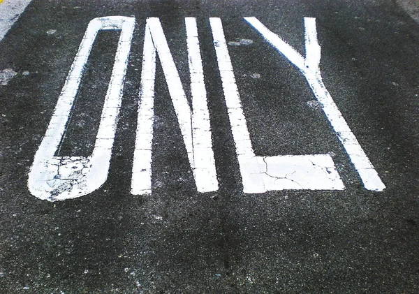 Only sign for traffic direction on an asphalt street