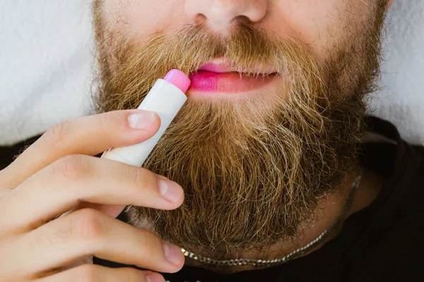 Close Bearded Man Applying Colorful Pink Lip Balm Lipstick His Royalty Free Stock Photos