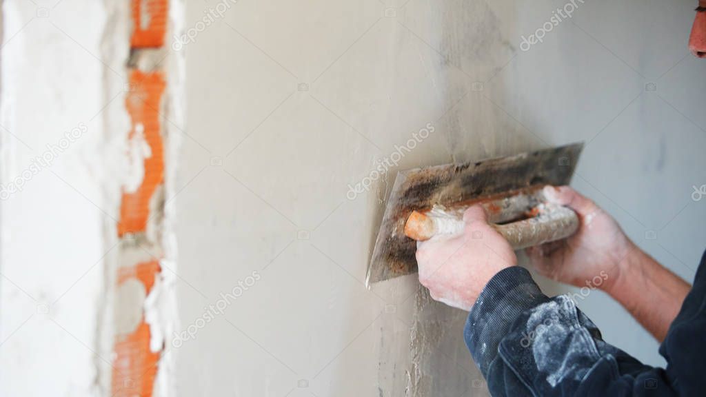 Bricklayer making concrete on building site