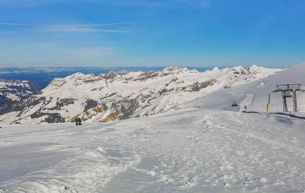 View from Mt. Titlis in Switzerland in winter. The Titlis is a mountain, located on the border between the Swiss cantons of Obwalden and Bern, it is usually accessed from the town of Engelberg on its northern side.