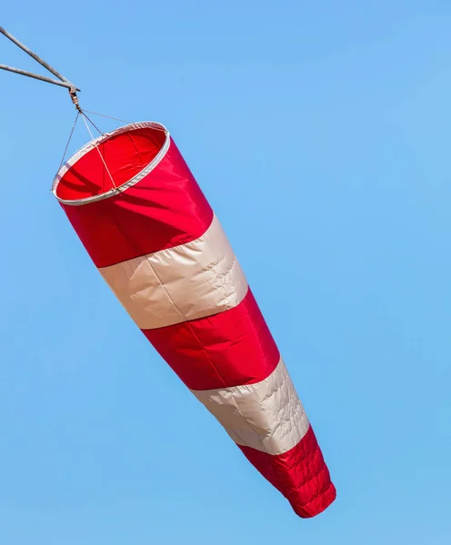 A windsock  in an airport against blue sky