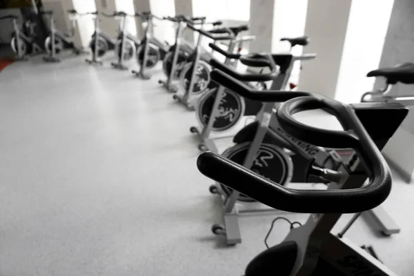 Modern Gym Interior Equipment Row Training Exercise Bikes Detail Backlight — Stock Photo, Image