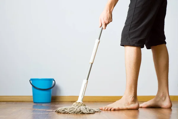 the man washes the floor in the apartment