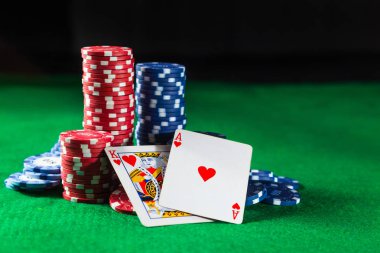 Yeşil bir arka plan üzerinde iki kart kral ve Ace Poker fişleri.