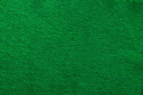 The green background on the poker table in the casino