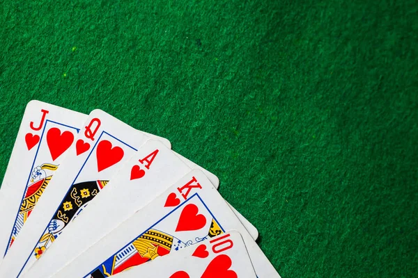 poker cards Royal Flush on green background with copy space