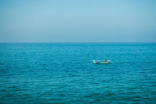 A small boat in calm sea ocean background