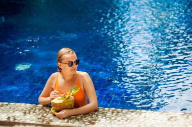 Havuzun içinde Hindistan cevizi ile kız