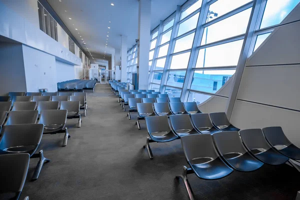 waiting room at the airport with gray chairs