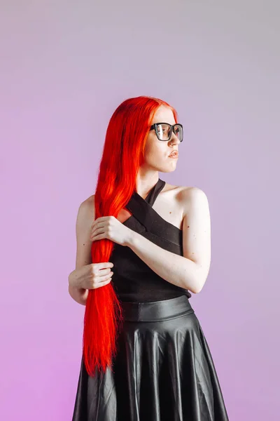 Girl with red long hair wearing glasses and leather skirt on pin — Stock Photo, Image