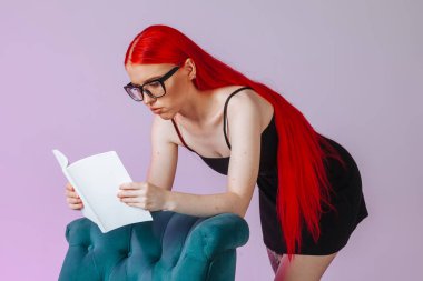 Pembe backgr üzerinde beyaz kitap mockup okuma kırmızı uzun saçlı kız