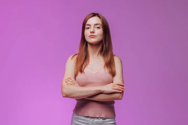 Girl crossed her arms against the pink background — Stock Photo, Image