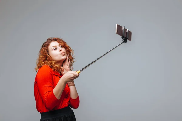 woman taking selfie wearing gray tank top by Ginger Girl. Photo stock -  StudioNow