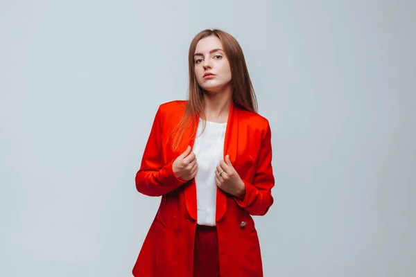 Chica en una chaqueta roja sobre un fondo claro — Foto de Stock