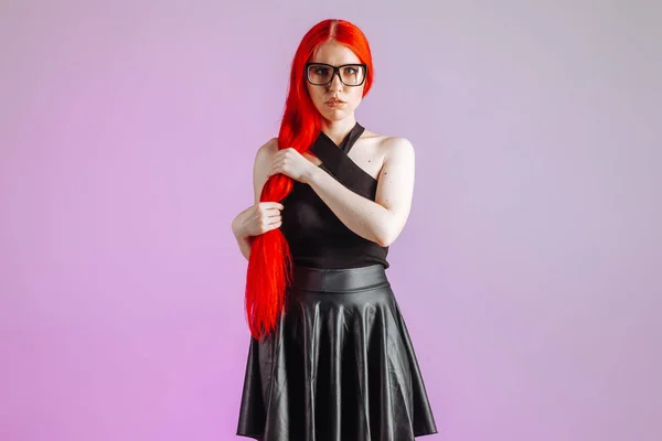 Girl with red long hair wearing glasses and leather skirt on pin — Stock Photo, Image