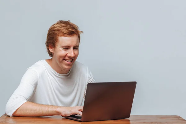 Lächelnder rothaariger Mann Programmierer auf hellem Hintergrund für a la — Stockfoto