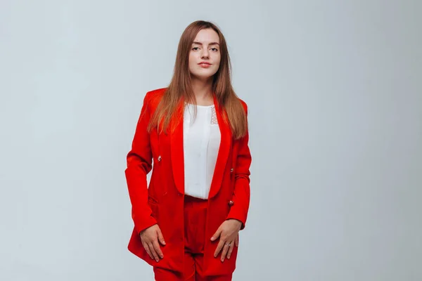 Girl in a red jacket on a light background — Stock Photo, Image