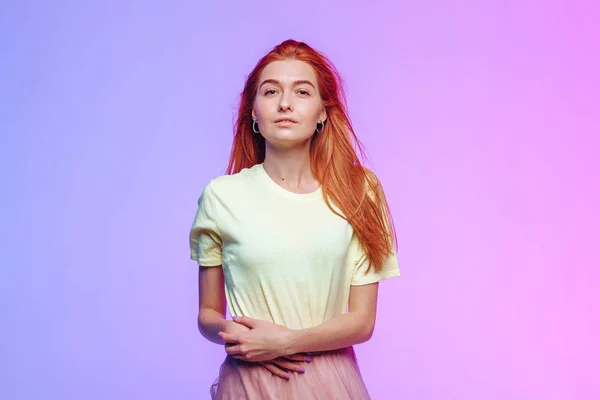 Red-haired girl posing on a colored background — Stock Photo, Image