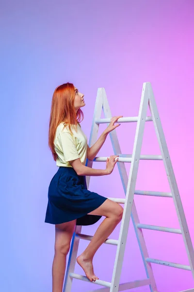 the girl climbs the ladder