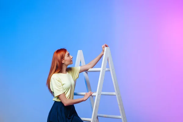the girl climbs the ladder