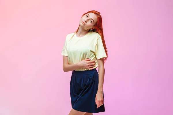 Redhead girl posing on pink background — Stock Photo, Image