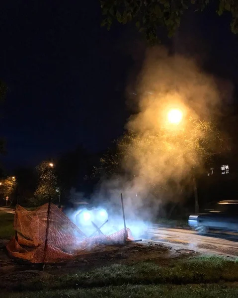 Steam is rising from repaired heat transport system at night