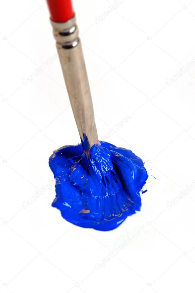 Brush mixing blue paint on canvas