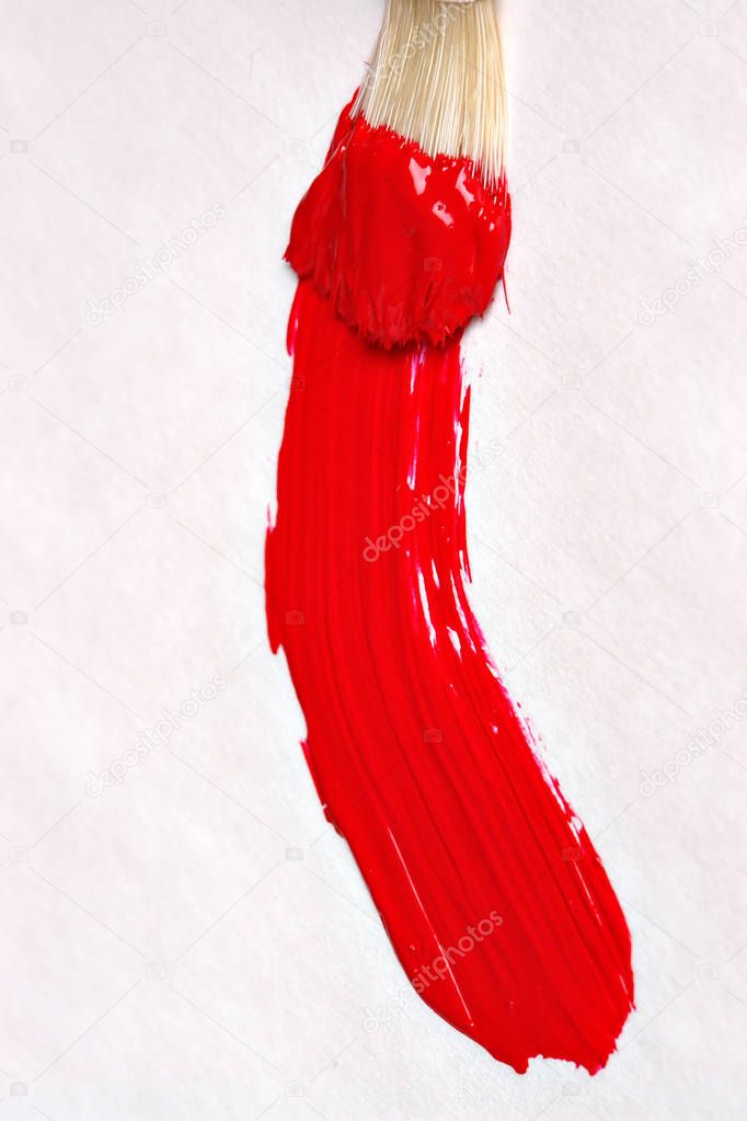 Red paint stroke on canvas