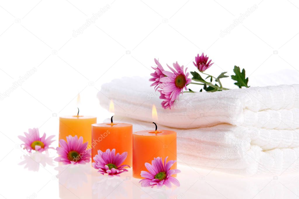 Candles, flowers, and white towels