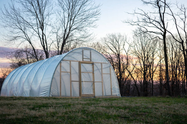 a green house at sunrise