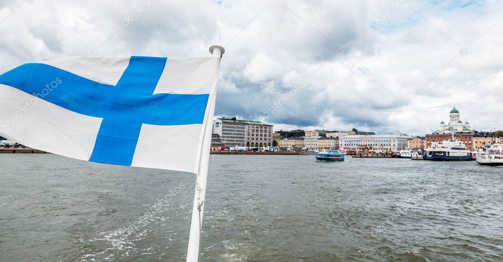 A Finnish flag on a boat, develops in the wind with a view of the sea. Travel to Finland, Scandinavian Europe