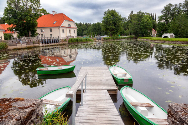 An old manor house Vihula in Estonia, Lahemaa park. Beautiful summer landscape with pond