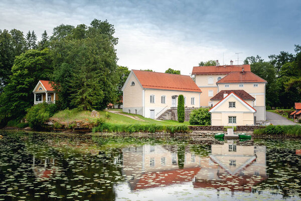 An old manor house Vihula in Estonia, Lahemaa park. Beautiful summer landscape with pond