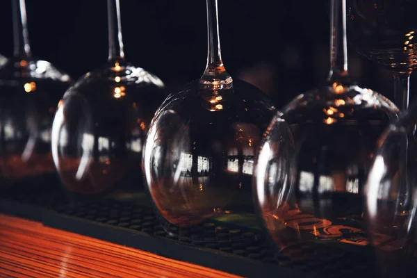 Wine glasses stand upside down on the bar in the restaurant, an abstract bar image, an image with retro toning