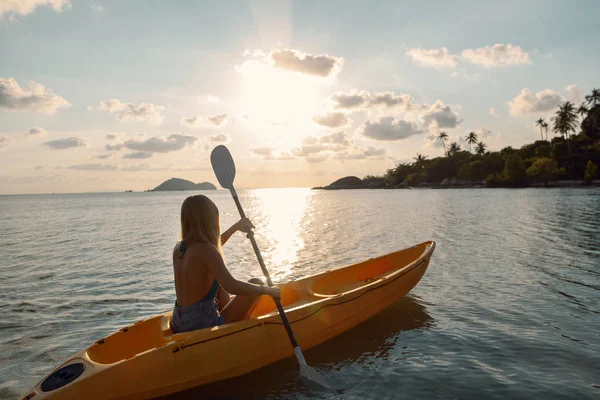 Girl  on kayak  sea at sunset, healthy lifestyle design. Sport,
