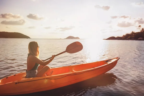 Girl  on kayak  sea at sunset, healthy lifestyle design. Sport,